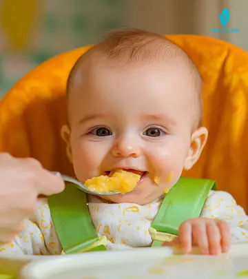 A mom feeding baby food to her child