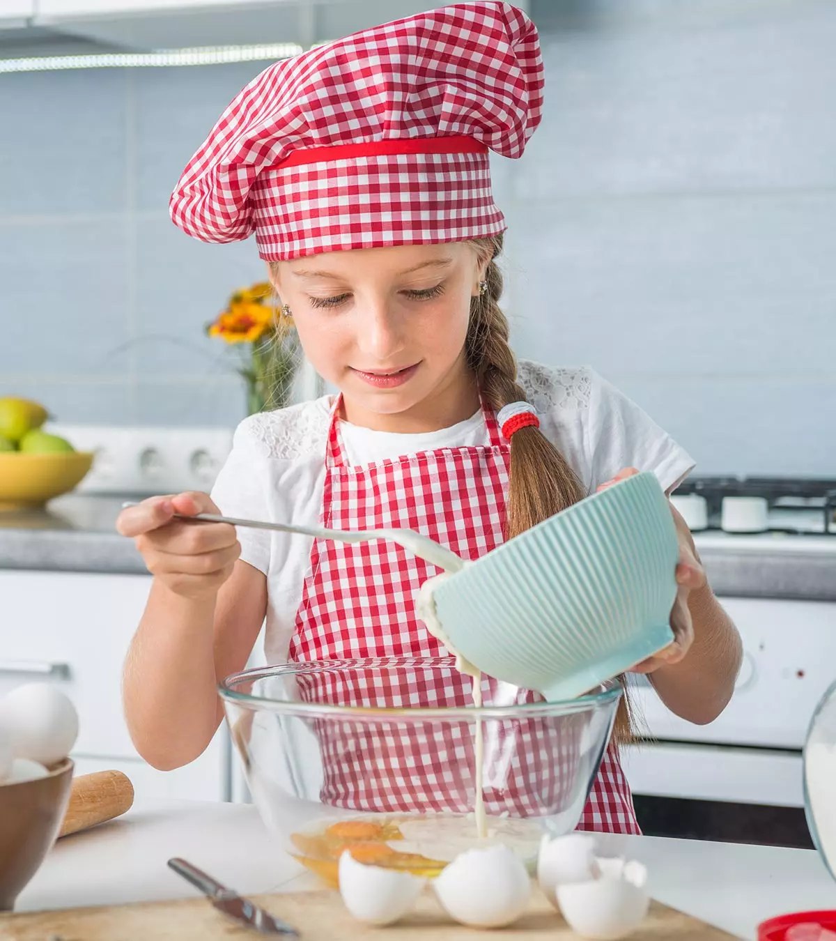 A kid is preparing some egg recipe