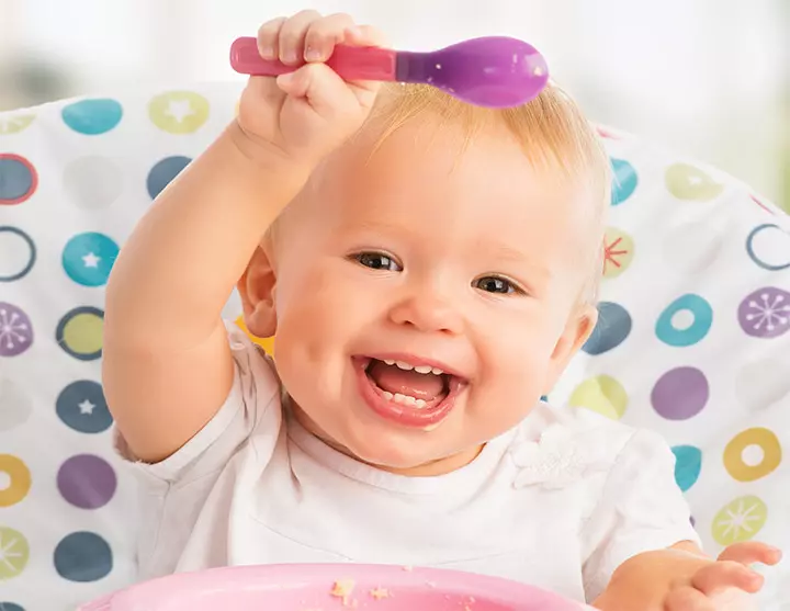 Really cute baby smiling with hands in the air picture