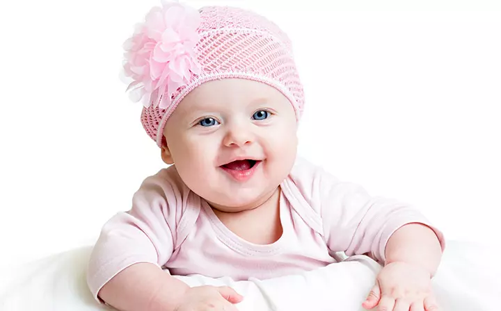 Smiling picture of baby with spoon in hand