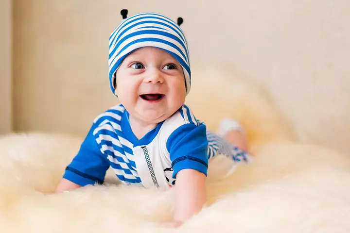 Cute and smiling picture of baby in blue clothes