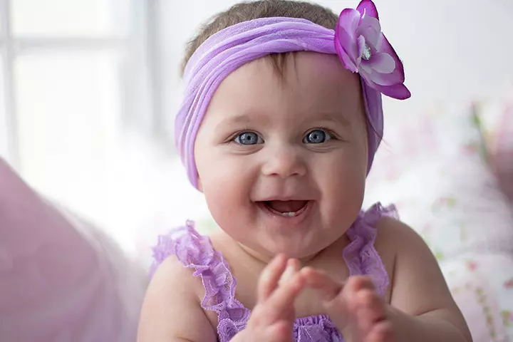 Smiling baby picture of little girl in violet dress