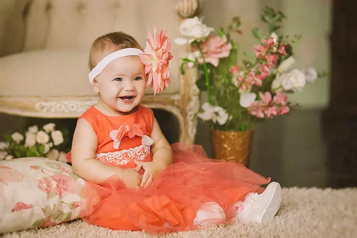 Smiling baby picture of child in orange dress