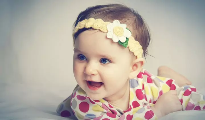 Smiling picture of baby girl with headband