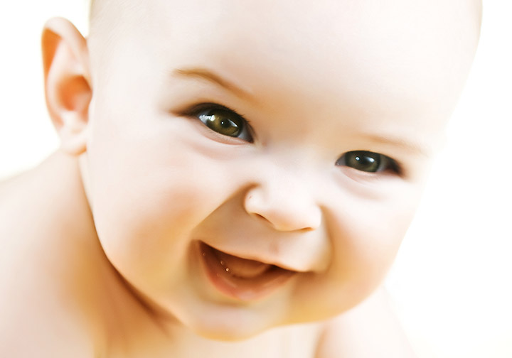 Cute baby boy with brown eyes smiling picture