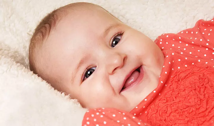 Smiling baby picture in red dress