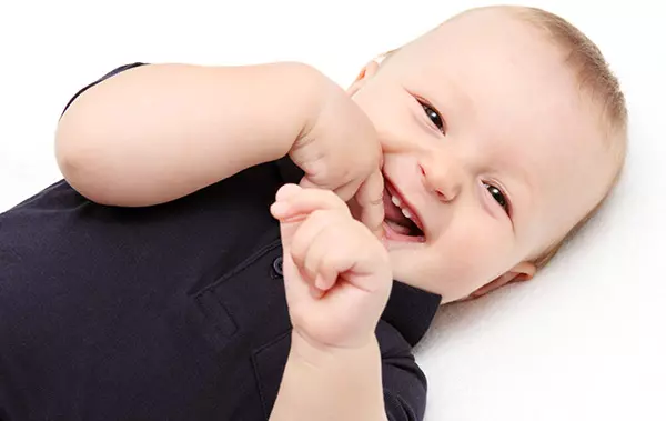 Cute baby boy smiling picture with hand inside the mouth