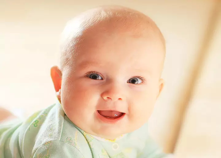 Picture of baby looking at the camera and smiling