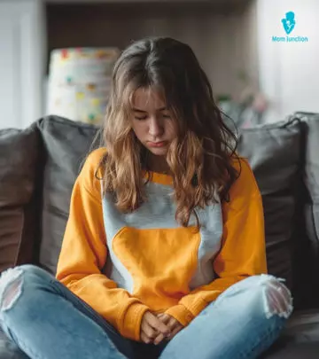 A boy and a girl watching laptop with their parents