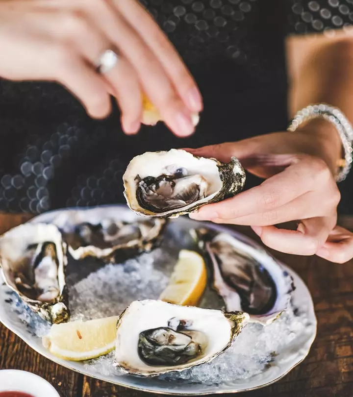 A Pregnant WOman Eating Oysters