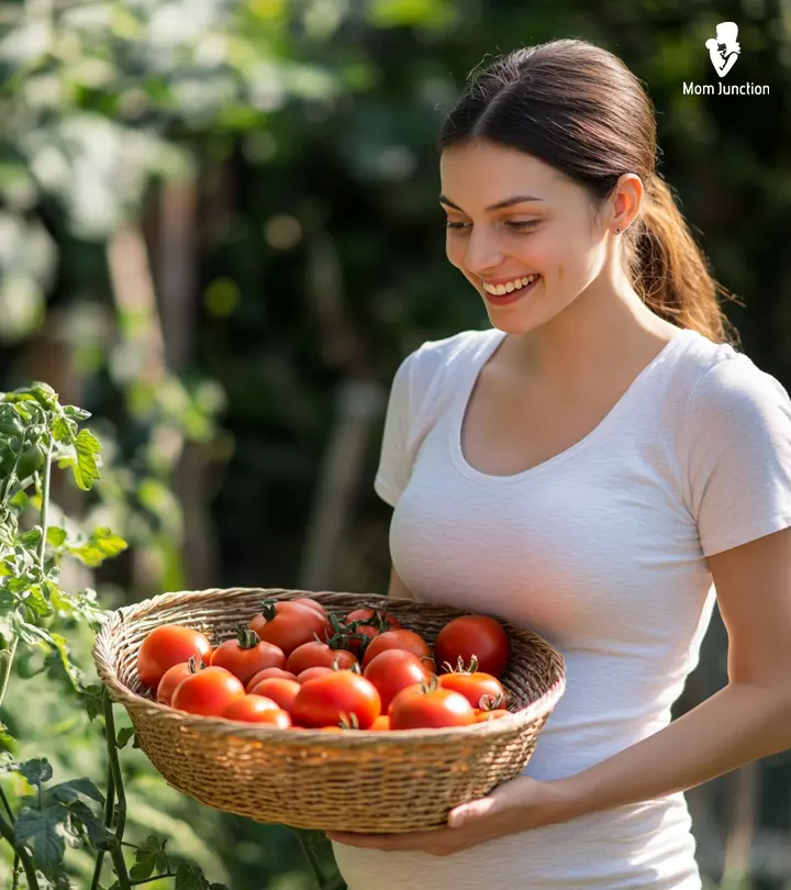 A lady holds lots of tomatoes