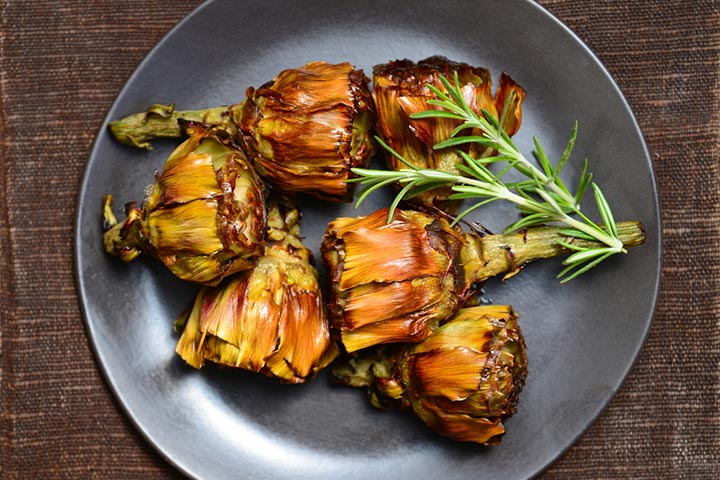 You can eat a cooked artichoke by seasoning it with salt and olive oil