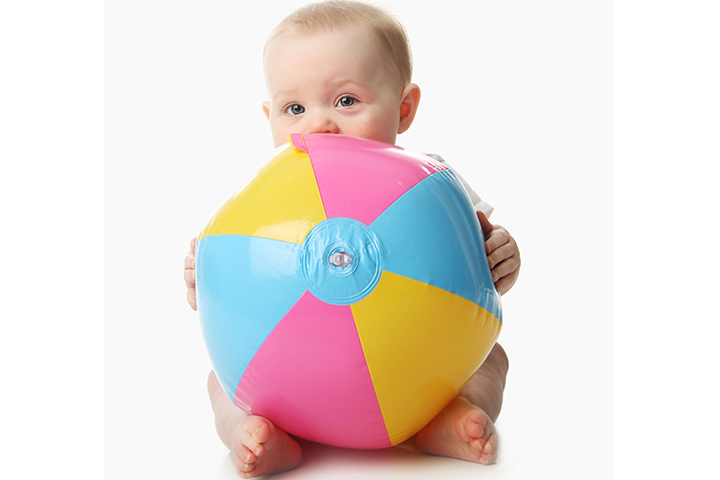 Beach ball rolling activity for 6-month-old baby