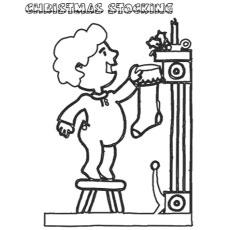 Girl putting up the Christmas stocking coloring page