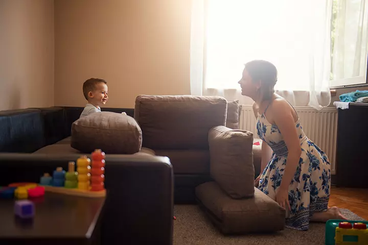 Child building a fort using pillows