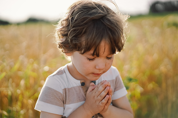 A child reciting a morning prayer