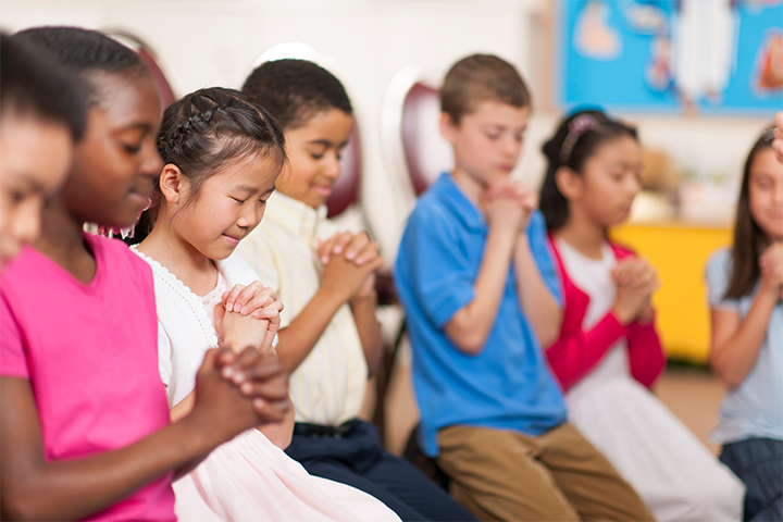 Children praying for a blessed day