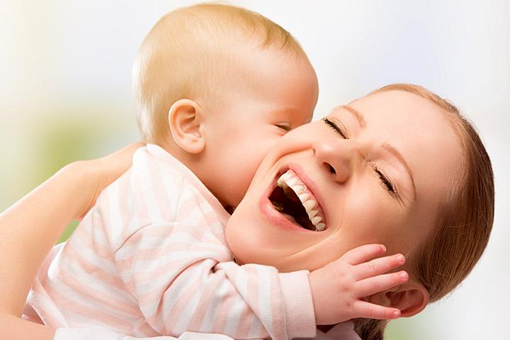 Mother kissing baby image