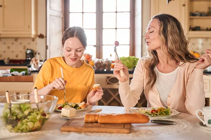 Mother helping teenage daughter make friends easily by brushing up conversational skills