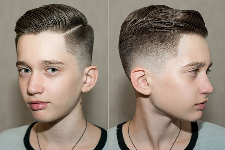 Smiling boy with stylish side-part hair.