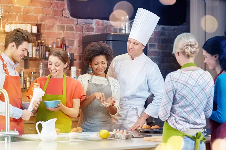 Teenager with friends and teacher in pottery class