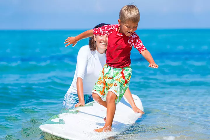 Give him his first lessons on surfing.