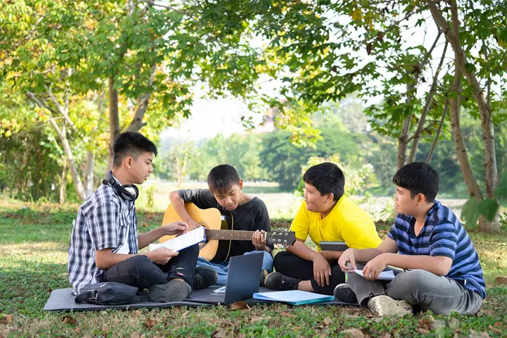 A group of teens composing a song.