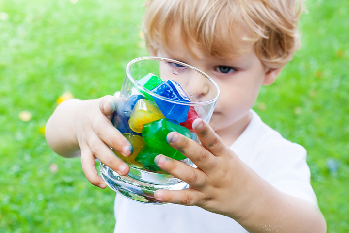 Child holding a bowl of colored ice