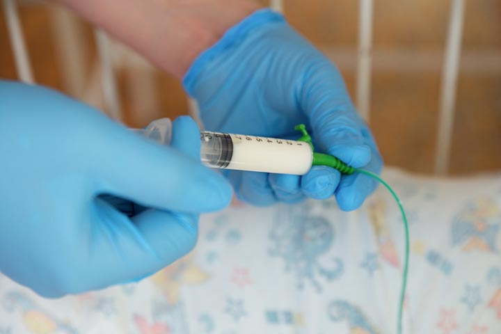 Doctors may listen over the stomach after pushing some air into the tube using a syringe.