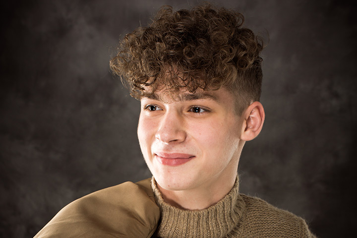 Undercut with long curly fringe for teenage guys