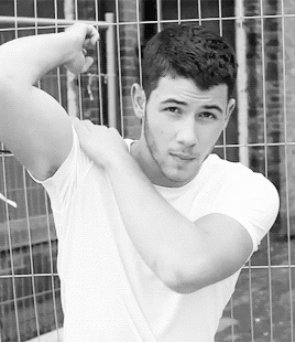Wouldn't you shoulder-massage Nick Jonas for his inviting look