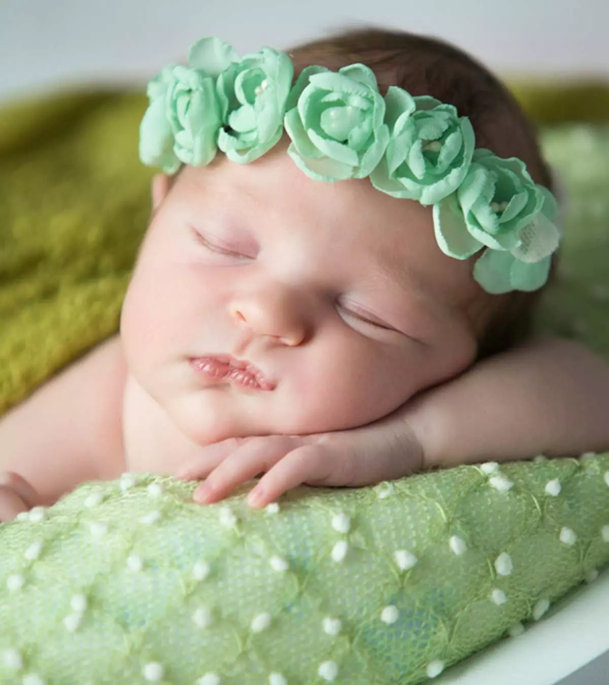 A newborn baby with a crown on his head