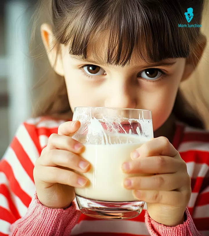 A small girl drinking Pediasure