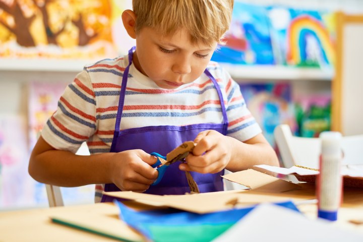 Child making paper plate craft