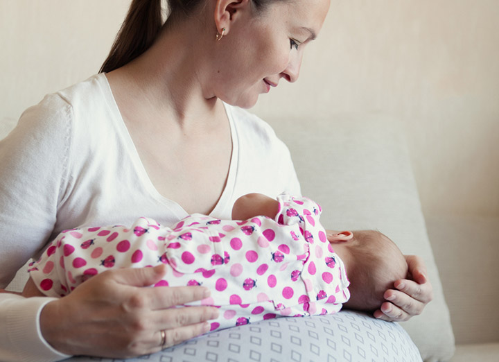 Pillow supported lap hold for breastfeeding after C section