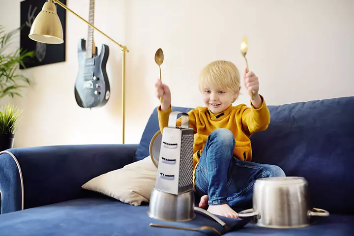 Recycling activities for kids, child playing with kitchen utensils