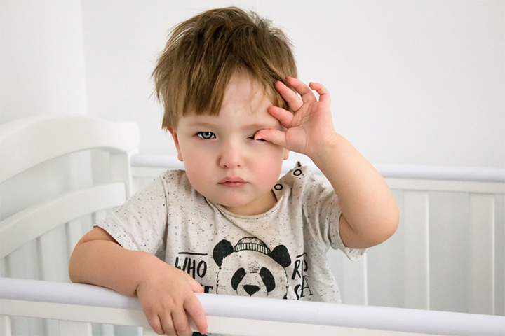 A sleepy toddler may rub their eyes at nap time
