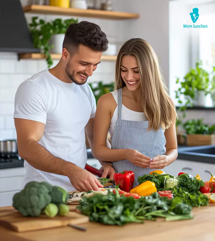 A Husbanf Helping His Wife In Kitchen