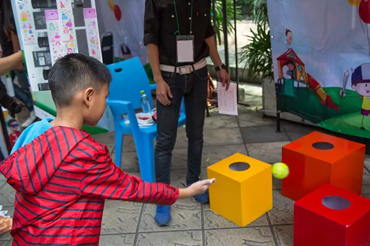 Tossing a ball into the box fun game for kids