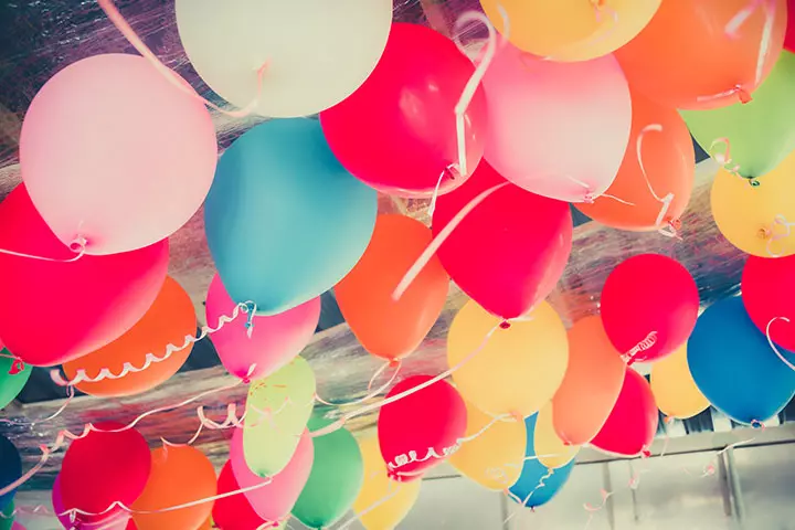 Party with colorful balloons for pregnancy announcement ideas