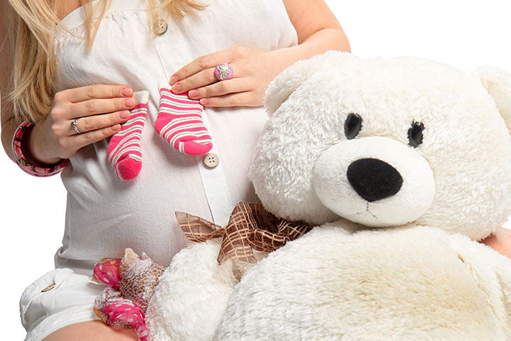 A picture with a soft toy maternity photoshoot idea