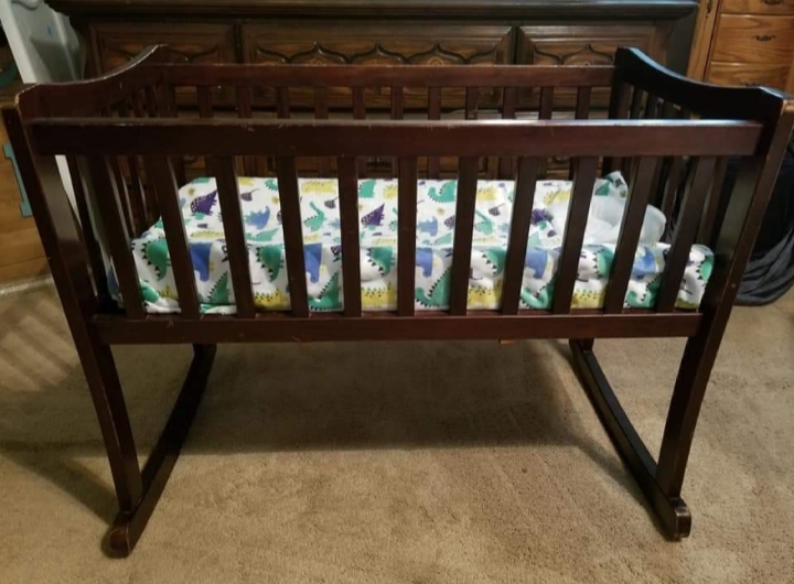 wooden cradle with mosquito net