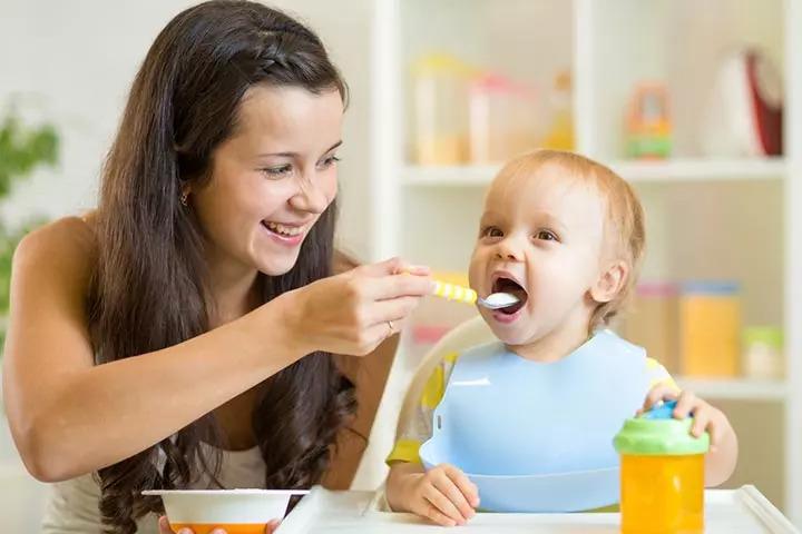 giving baby porridge