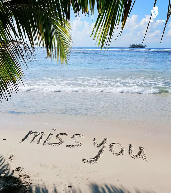 Miss you text written on a beach