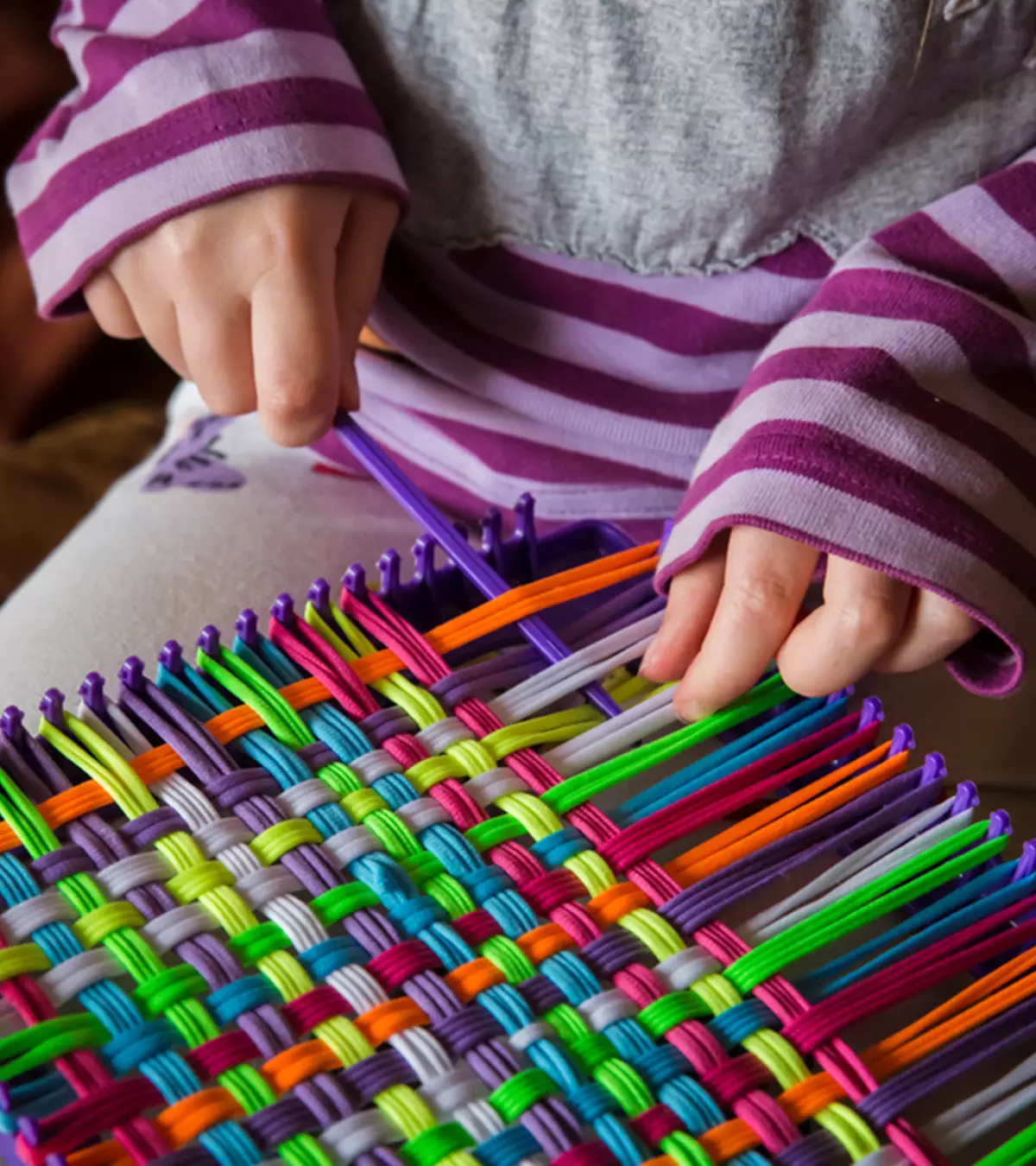 A Kid Doing Weaving Project