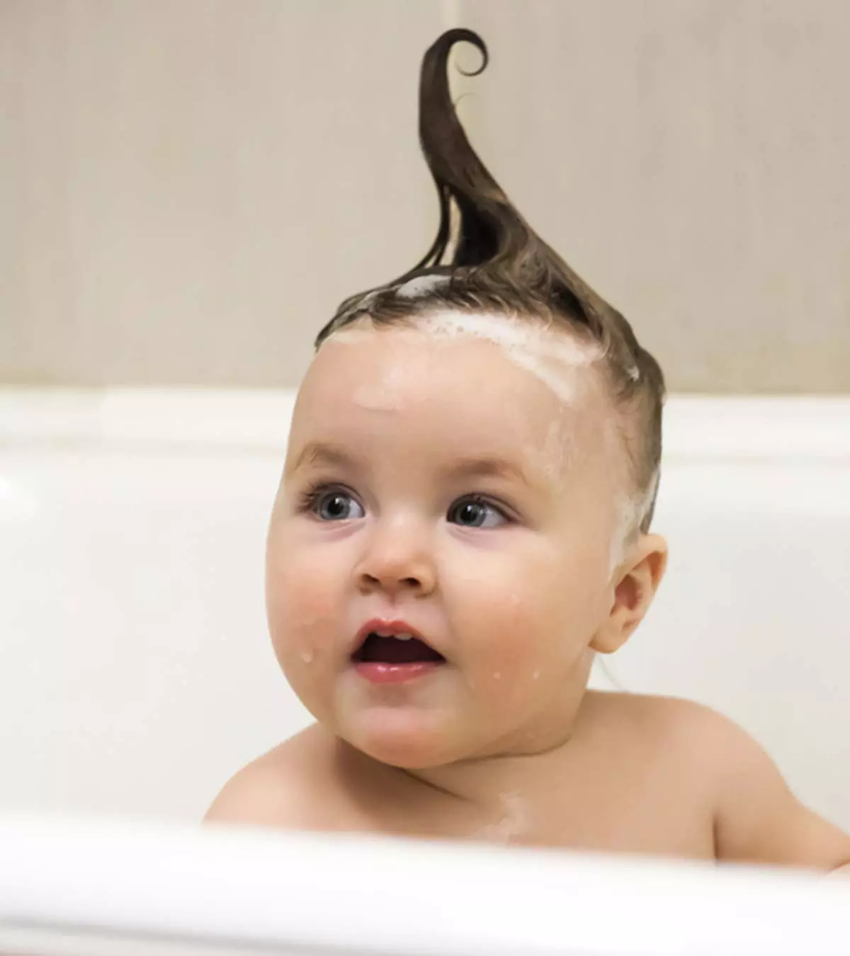 A Concerned Mother Examining Her Baby's Hair, Representing The Issue Of Hair Loss In Infants