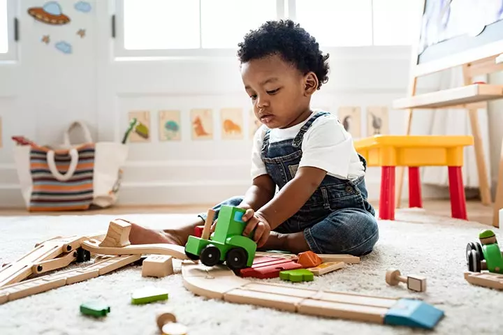 Holding and looking at a toy is an example of solitary play