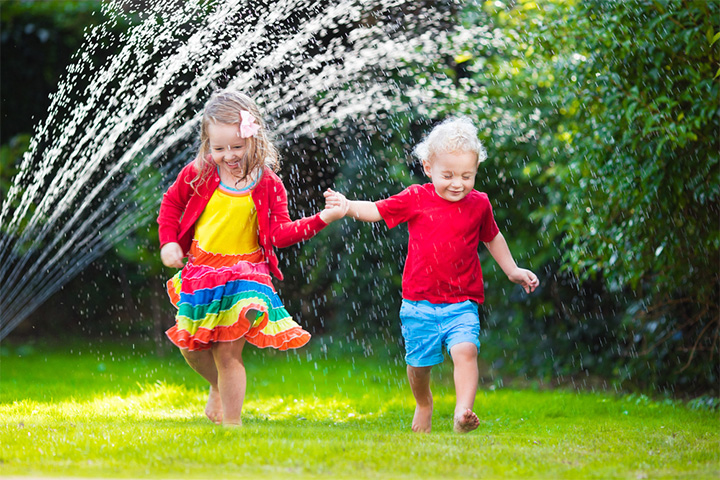 Children racing through sprinklers