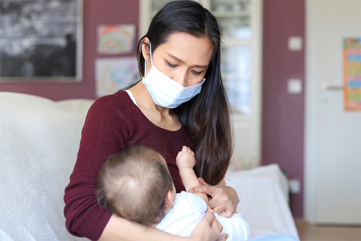 Nurse with mask on to prevent sinus infection while breastfeeding