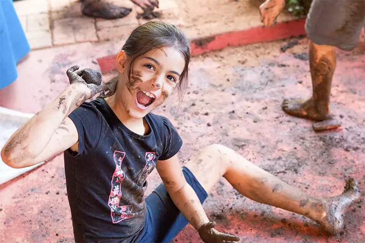 Kids building and playing in the mud